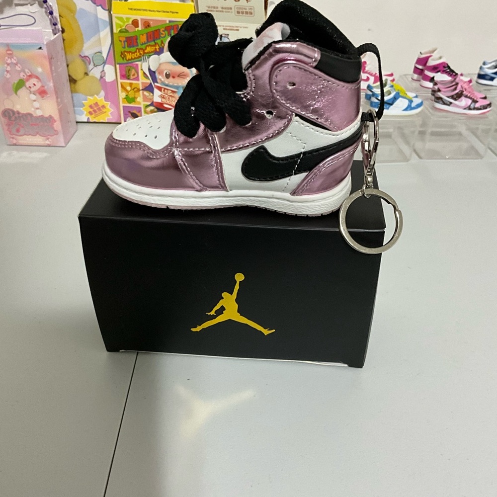 Nike Metallic Pink and Black phone charger & more! Also a Keychain Sneaker